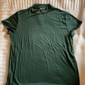 Mock neck, short-sleeve forest green top. Dressier look.